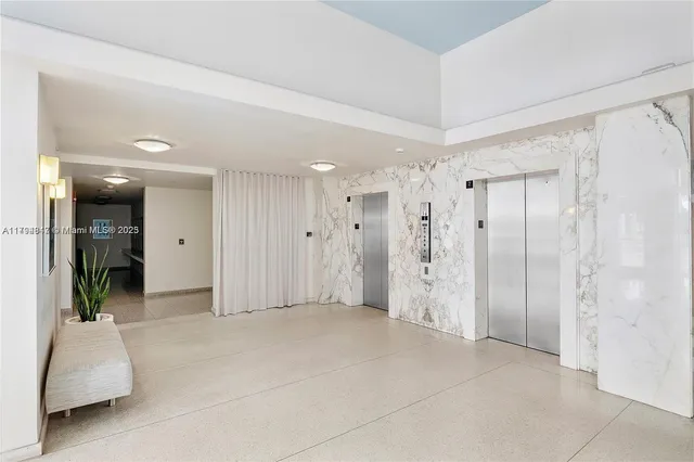 a view of a street with potted plants and large trees