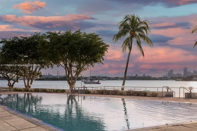 a view of a terrace with a bench and trees