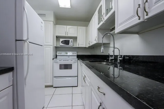 a kitchen with stainless steel appliances granite countertop a sink and a stove