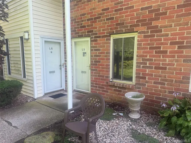 a view of a patio with table and chairs and potted plants