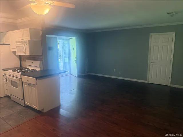 a kitchen with a sink cabinets and a window