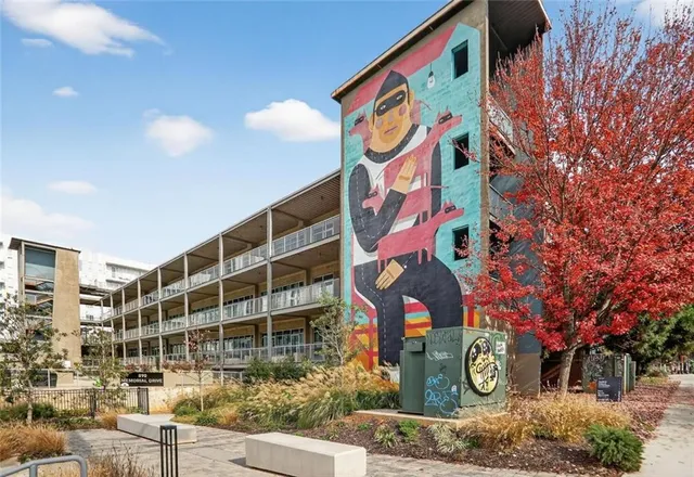 a swimming pool with buildings in the background