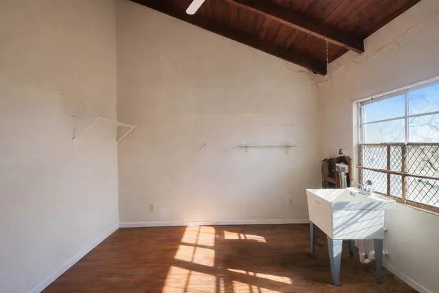 a view of a workspace with furniture and a window
