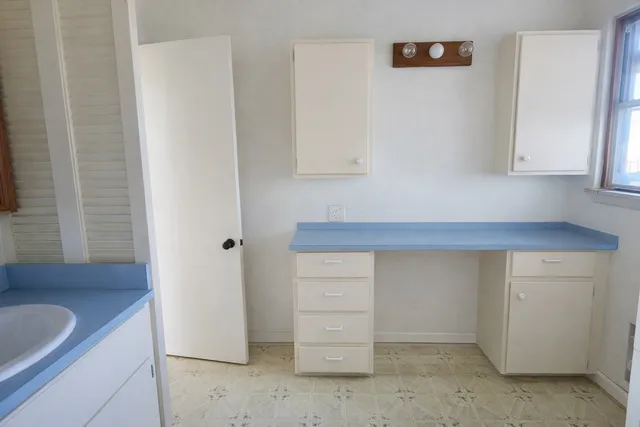 a kitchen with a sink and a refrigerator