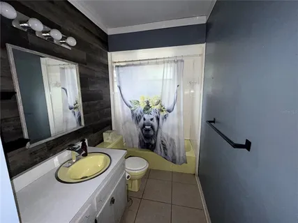 a bathroom with a granite countertop sink a toilet and a mirror