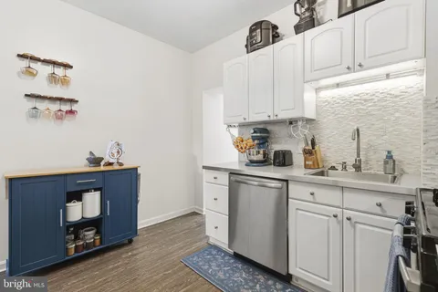 a kitchen with stainless steel appliances a white cabinets and a sink