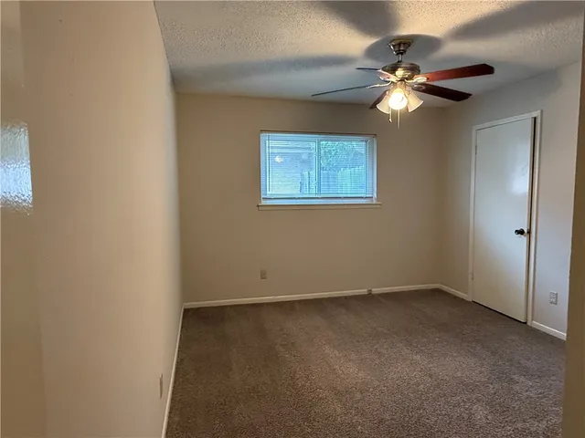 a view of an empty room with a fan