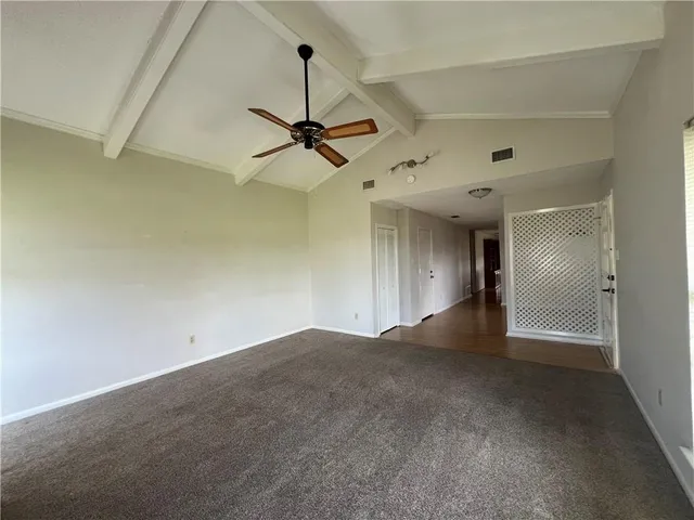 a view of an empty room with a ceiling fan