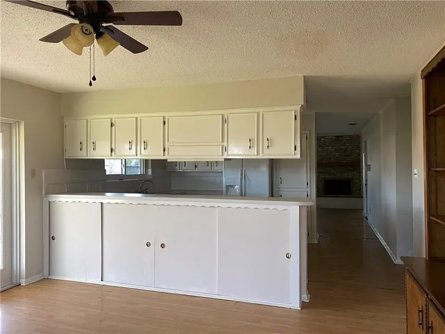 a kitchen with stainless steel appliances a stove refrigerator and cabinets
