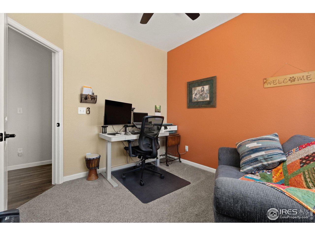 1833 Sunset Circle Milliken, CO 80543 - Photo 11 of 21 a living room with furniture and a flat screen tv