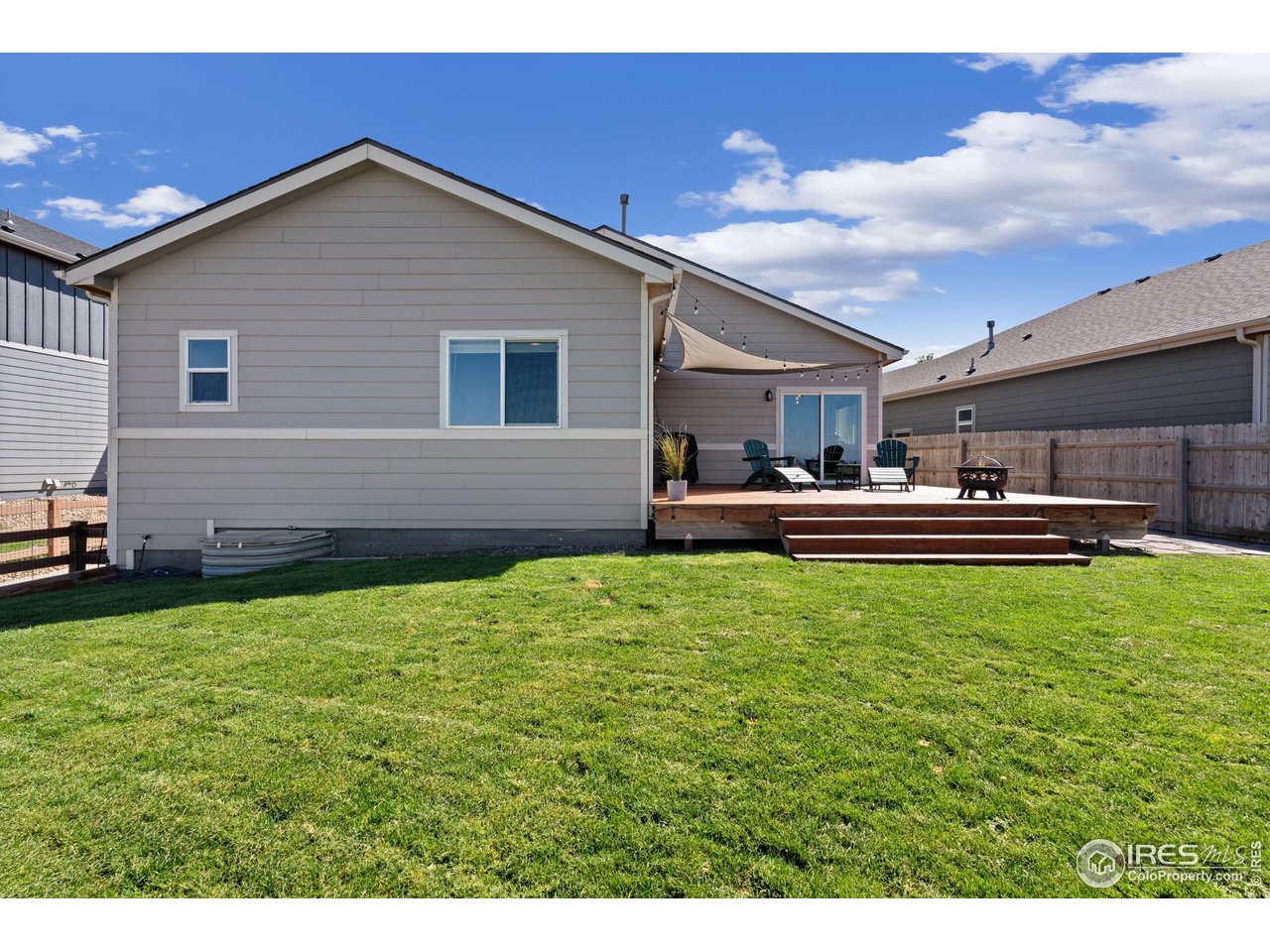 1833 Sunset Circle Milliken, CO 80543 - Photo 14 of 21 a backyard of a house with table and chairs