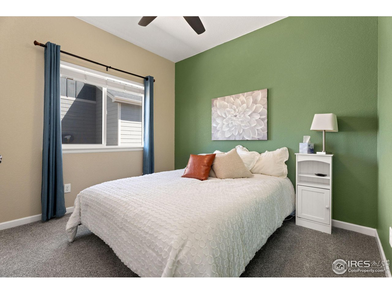 1833 Sunset Circle Milliken, CO 80543 - Photo 10 of 21 a bedroom with a bed and a painting on the wall