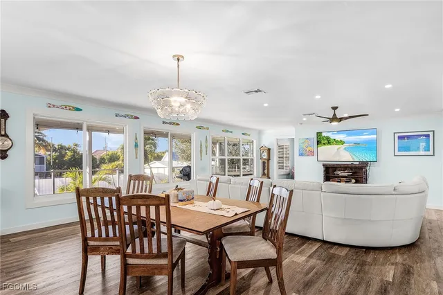 a view of a dining room with furniture wooden floor and chandelier