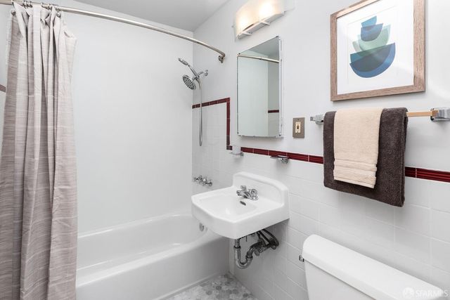 a bathroom with a shower and a sink