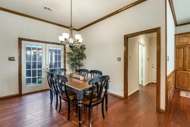 a dining room with furniture wooden floor and a chandelier