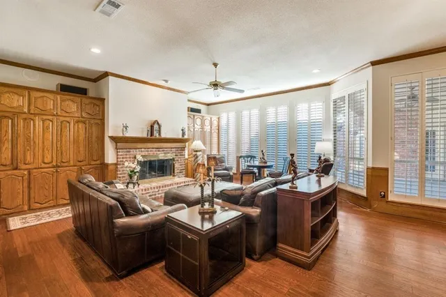 a living room with fireplace furniture and a large window