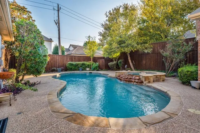 a swimming pool with outdoor seating and yard