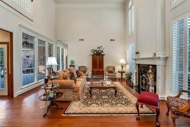 a living room with fireplace furniture and a large window