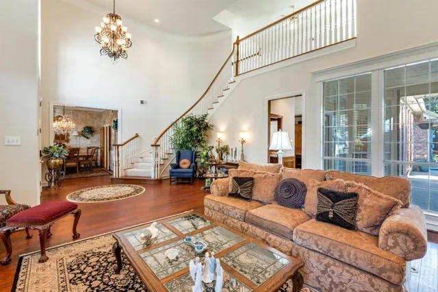a living room with furniture and a chandelier