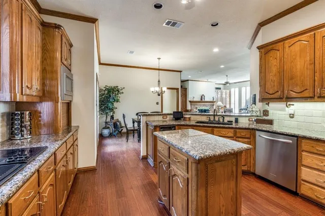 a kitchen with stainless steel appliances granite countertop a stove and refrigerator