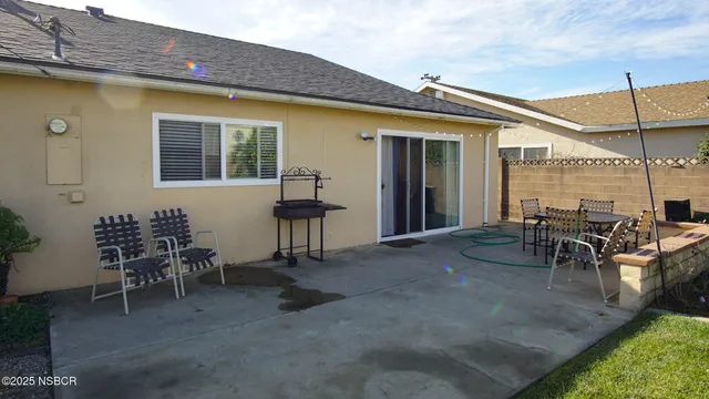a view of a patio with table and chairs and potted plants