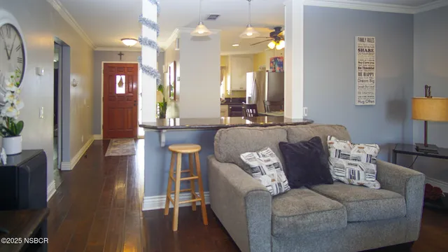 a living room with furniture and a chandelier