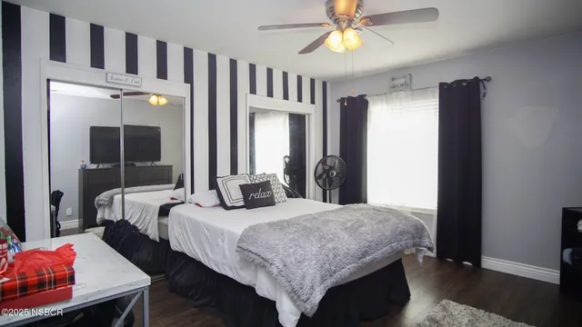 a bedroom with bed and a chandelier