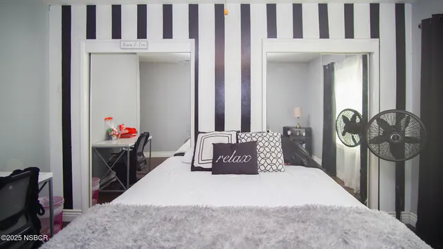 a bedroom with a bed and a mirror