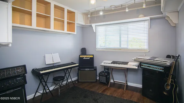 a view of a workspace with furniture and a window