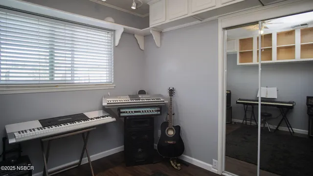 a room with a piano a stove and a window