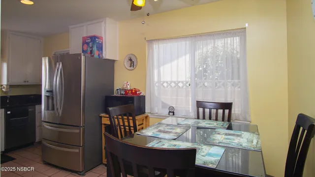 a kitchen with granite countertop a refrigerator and a stove top oven