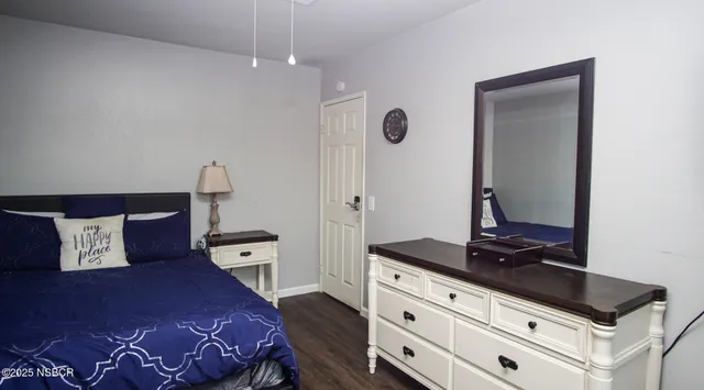 a bedroom with a bed and a dresser