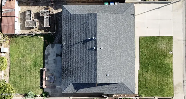 a aerial view of a house with a yard