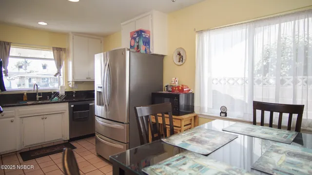 a kitchen with stainless steel appliances kitchen island granite countertop a refrigerator and a stove top oven