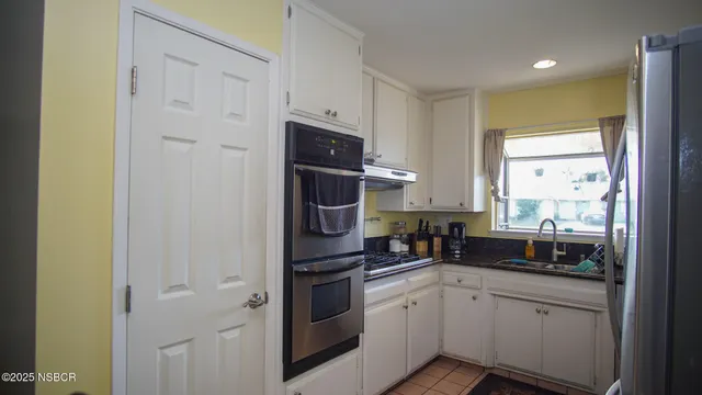 a kitchen with a refrigerator a sink and a stove