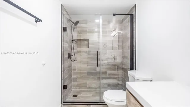 a bathroom with a shower and a toilet