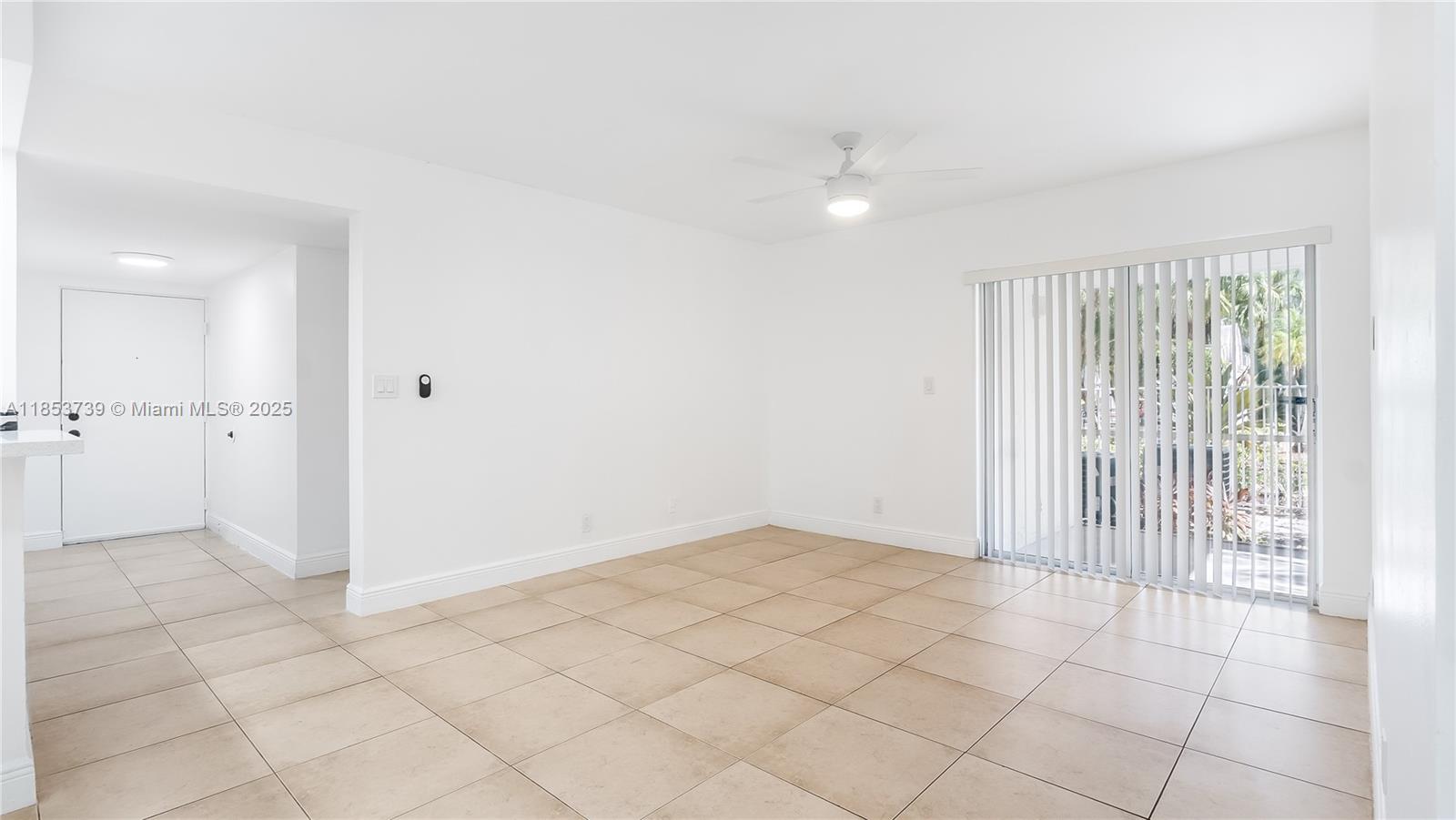 5686 Rock Island Road, Unit 106 Tamarac, FL 33319 - Photo 13 of 34 an empty room with white walls and tiles