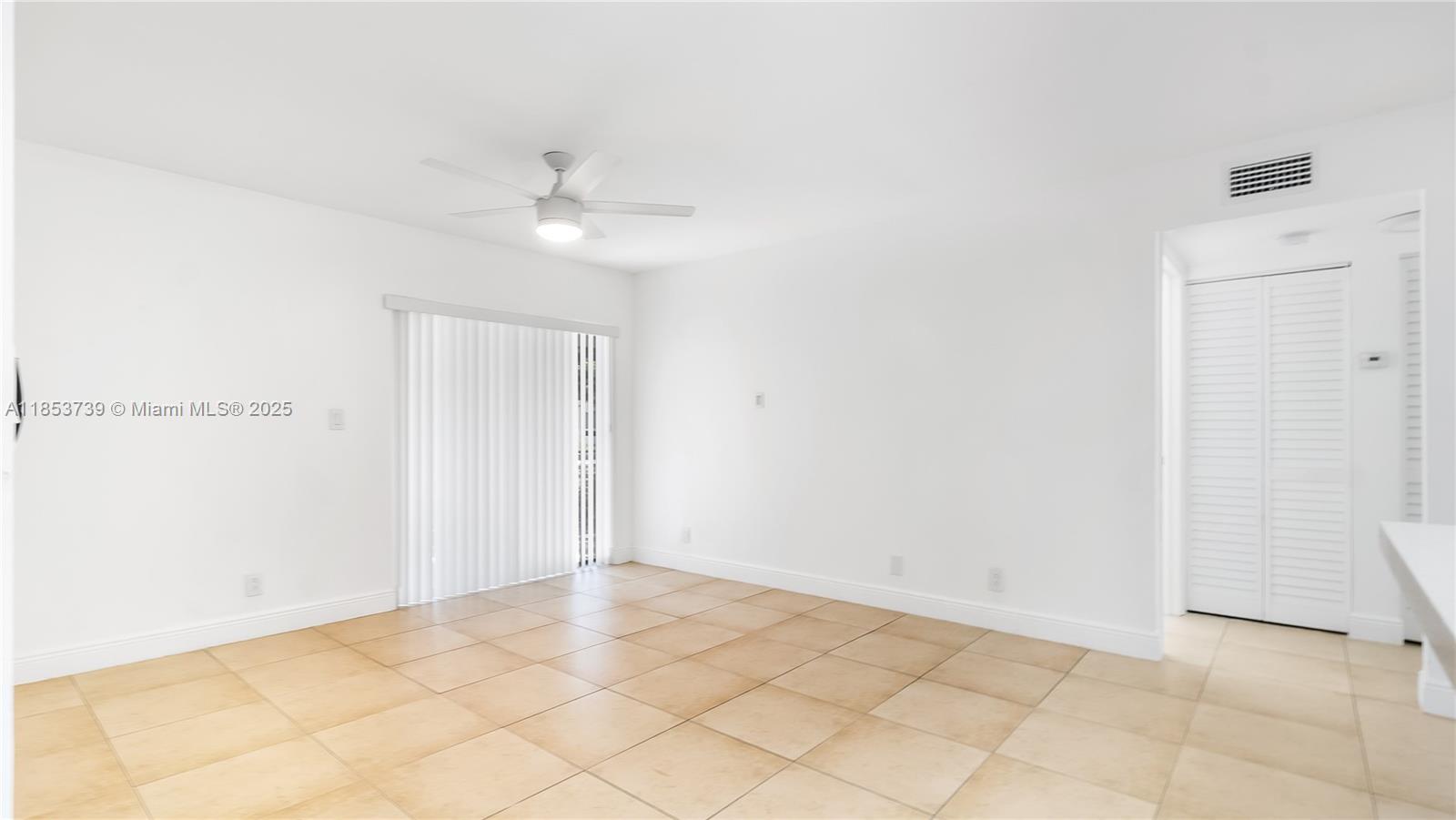 5686 Rock Island Road, Unit 106 Tamarac, FL 33319 - Photo 14 of 34 an empty room with a ceiling fan and a window