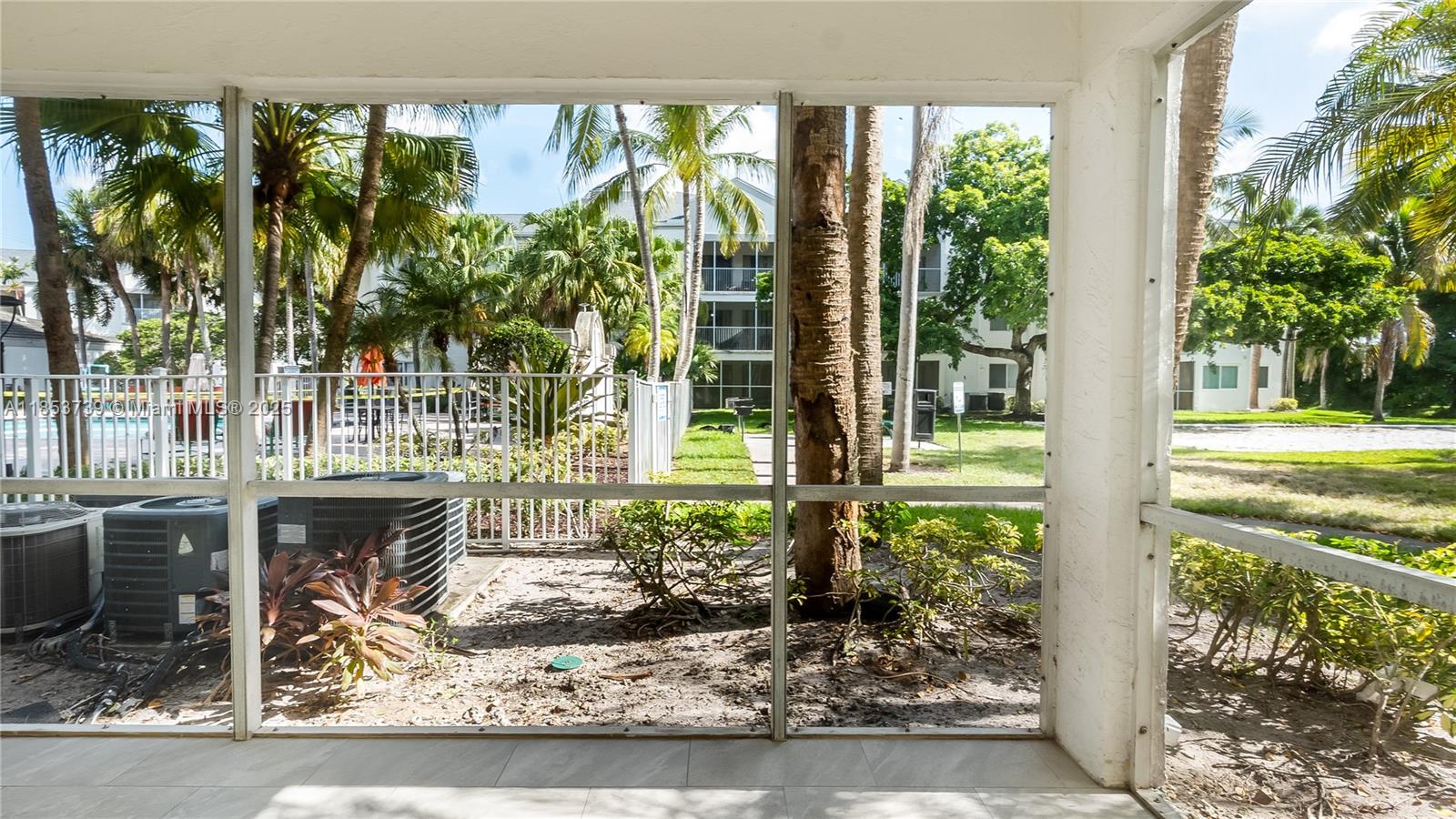 5686 Rock Island Road, Unit 106 Tamarac, FL 33319 - Photo 29 of 34 a front view of a house with a yard