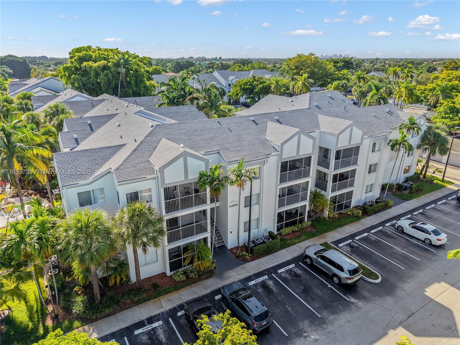 5686 Rock Island Road, Unit 106 Tamarac, FL 33319 - Photo 33 of 34 an aerial view of multiple houses with a yard