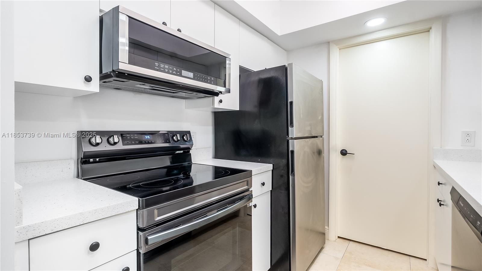 5686 Rock Island Road, Unit 106 Tamarac, FL 33319 - Photo 4 of 34 a kitchen with a stove and a microwave
