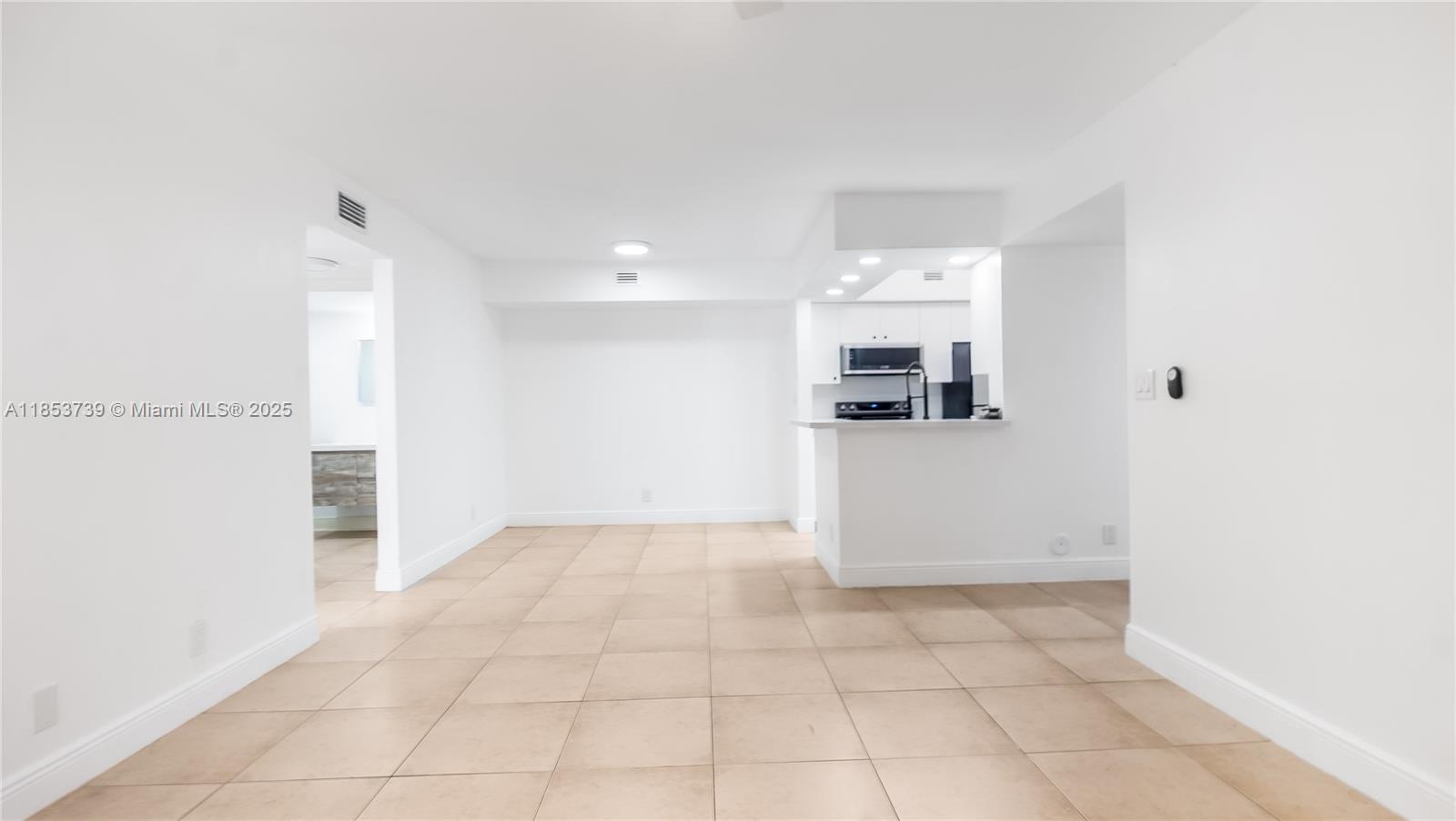 5686 Rock Island Road, Unit 106 Tamarac, FL 33319 - Photo 7 of 34 an empty room with kitchen and window