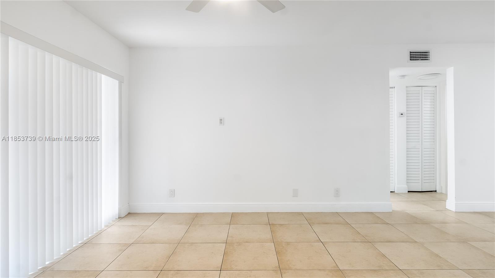5686 Rock Island Road, Unit 106 Tamarac, FL 33319 - Photo 8 of 34 an empty room with a empty space and windows