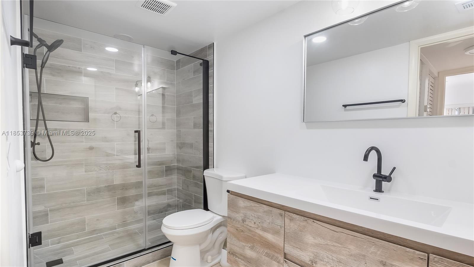 5686 Rock Island Road, Unit 106 Tamarac, FL 33319 - Photo 9 of 34 a bathroom with a sink and a mirror