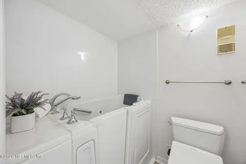 a view of a lake with a floor to ceiling window next to a yard