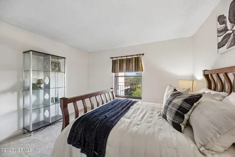 a living room with furniture tv and window