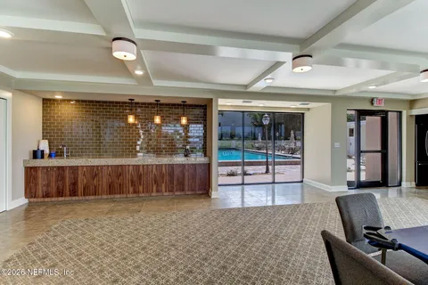 a view of a swimming pool with a table and chairs
