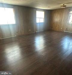 21628 Great Mills Road, Unit A2 Lexington Park, MD 20653 - Photo 4 of 11 an empty room with wooden floor and windows
