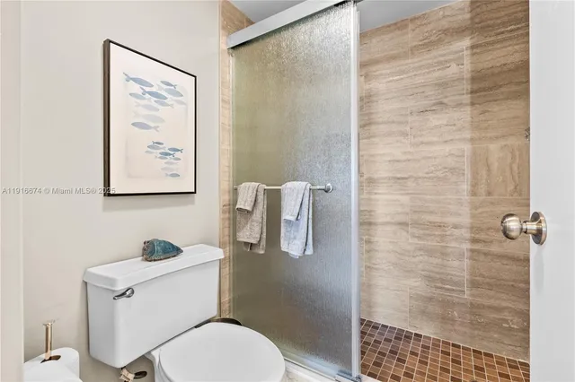 a white toilet sitting next to a bathroom sink