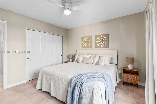 a bedroom with a bed and a night stand